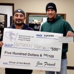 Anthony Martinez is awarded bonus check from director of Livestock Division, Jason Greer